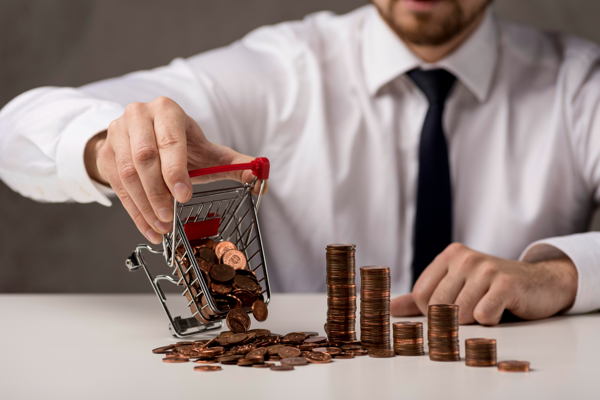 Office professional pushing a cart of coins representing equity capital and financial growth.